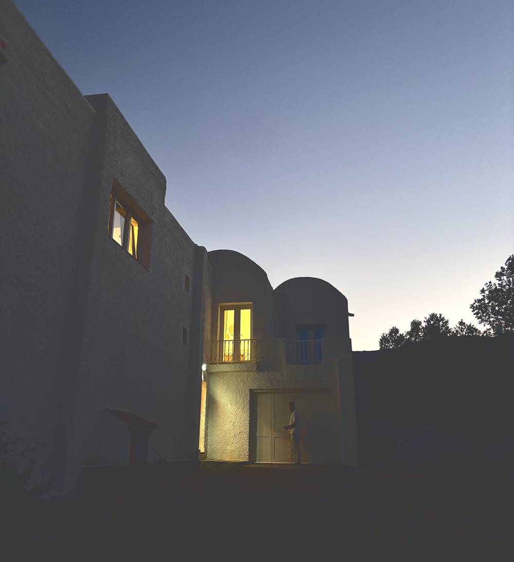 The house at nightfall, lit from within