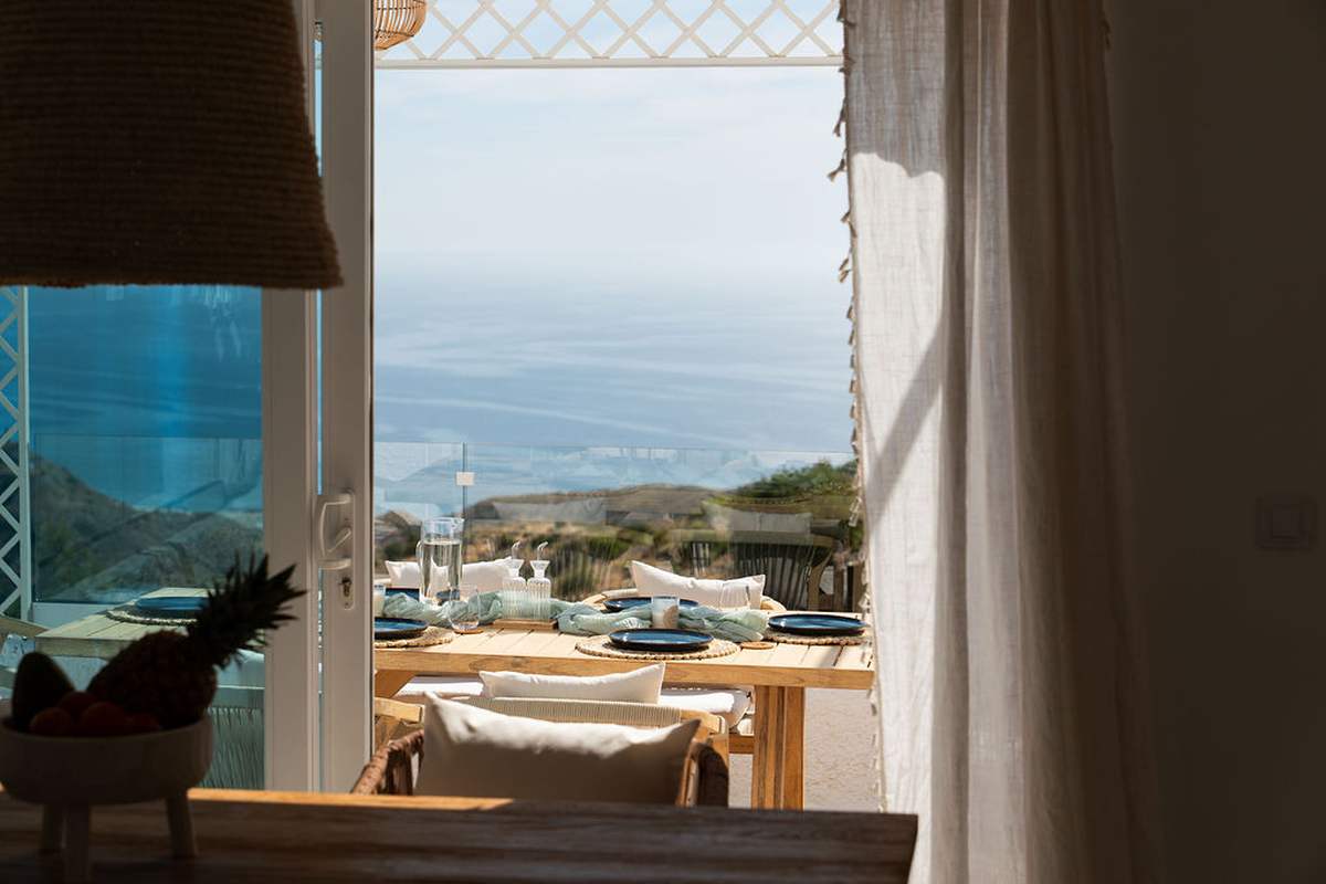 Loungers under the white pergola facing the sea